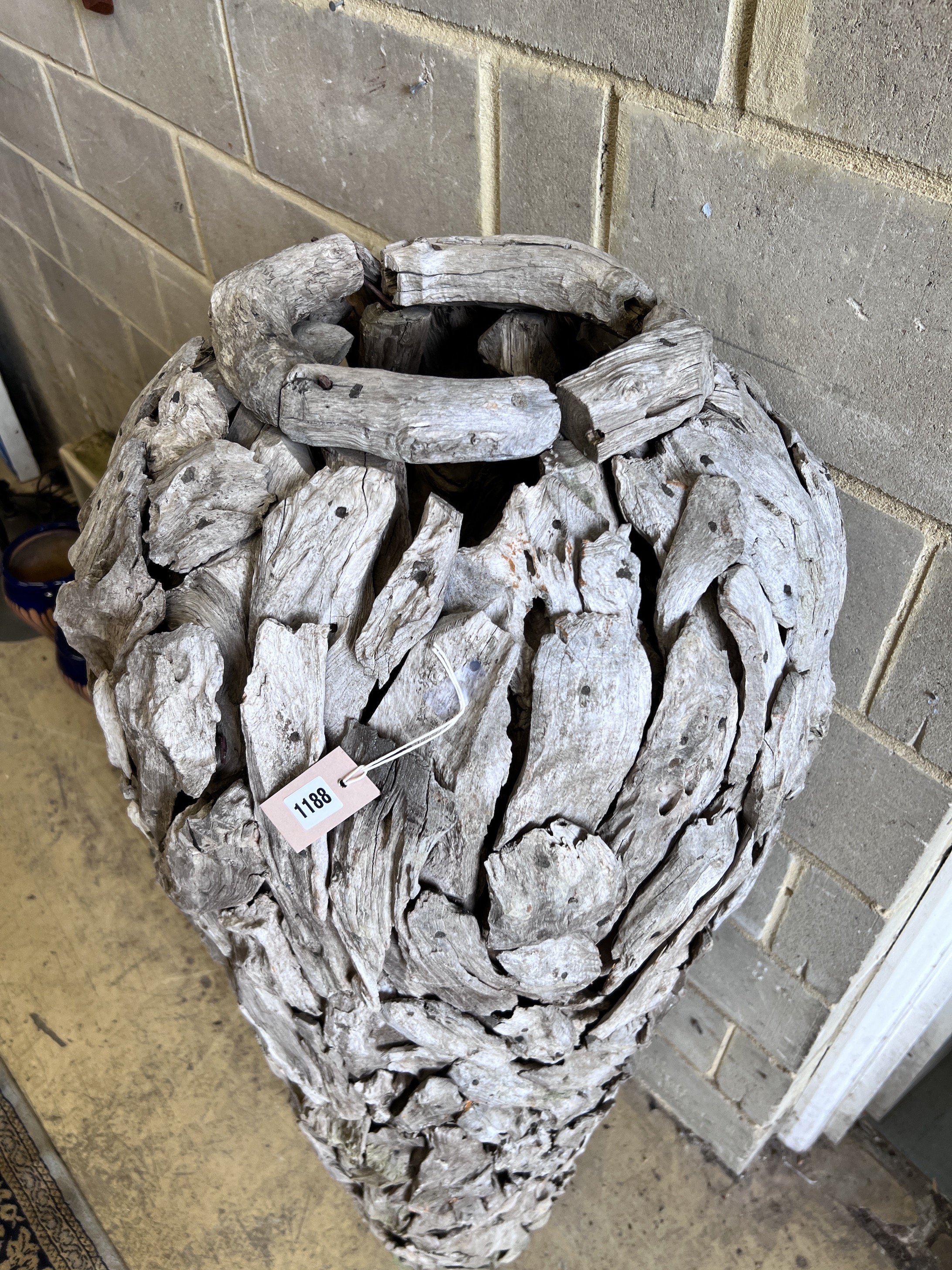 A large driftwood urn shaped garden ornament, height 155cm